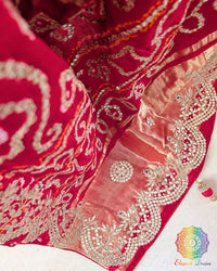 Close-up of the palla of the Red Gaji Silk Gharchola Saree, showcasing the intricate Gota Patti embellishments, traditional patterns and rich Gaji Silk texture.