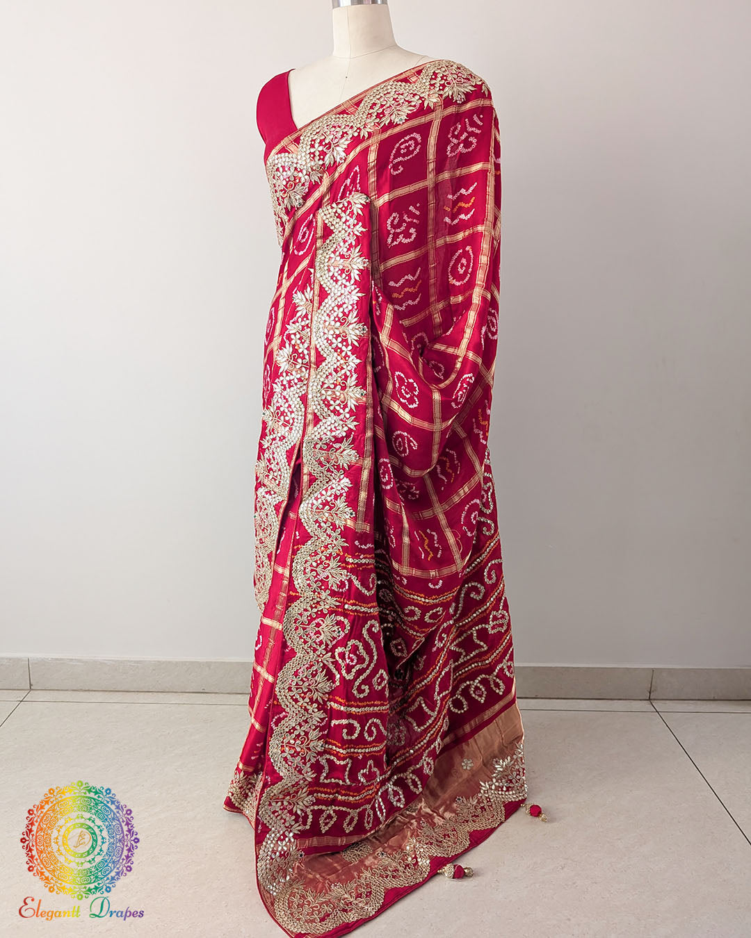 Red Gaji Silk Gharchola Saree in a side drape view, highlighting the graceful fall of the silk fabric and traditional Gota Patti detailing.