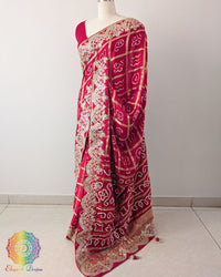 Red Gaji Silk Gharchola Saree in a side drape view, highlighting the graceful fall of the silk fabric and traditional Gota Patti detailing.
