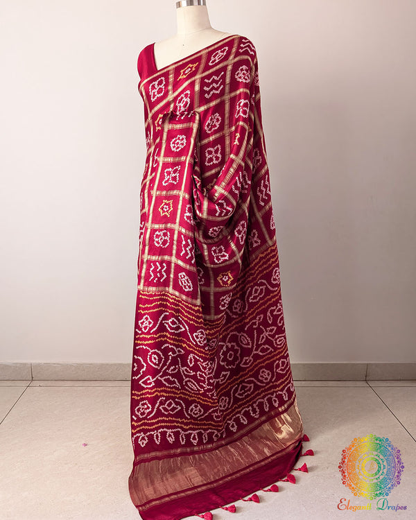 Red Gharchola Pure Gajji Silk Bandhani Saree in a side drape view, highlighting the graceful fall of the silk fabric and traditional Bandhani design.
