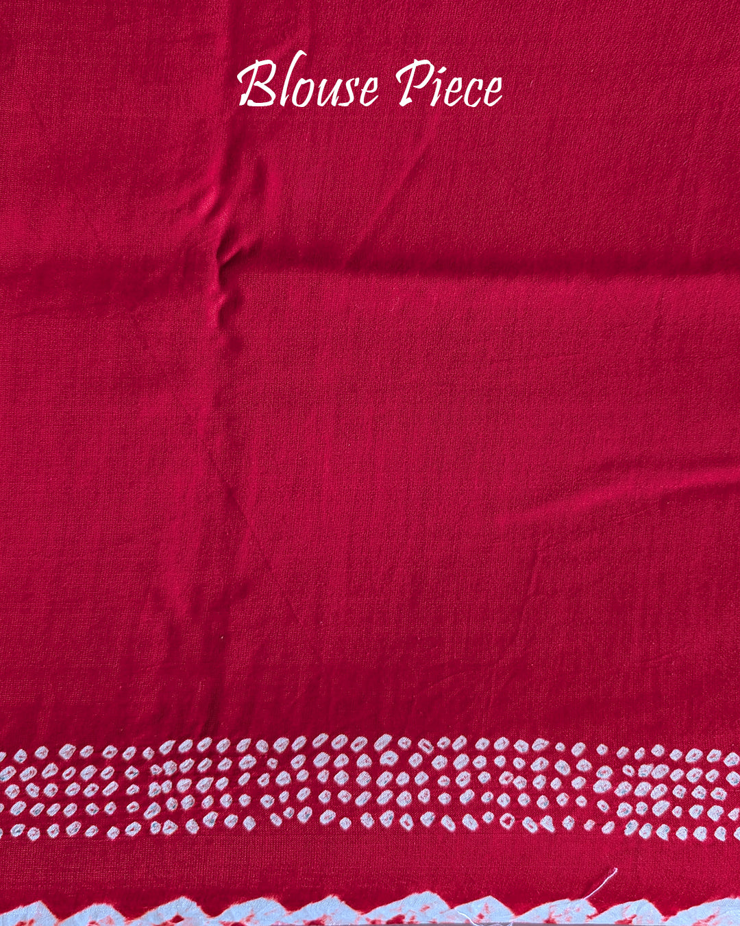Matching blouse piece in red bareek bandhej gaji silk fabric showing pattern detail
