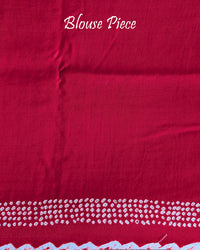 Matching blouse piece in red bareek bandhej gaji silk fabric showing pattern detail