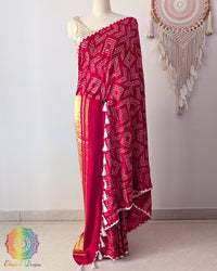 Red pure gaji silk saree on mannequin showcasing fine bareek bandhej pattern