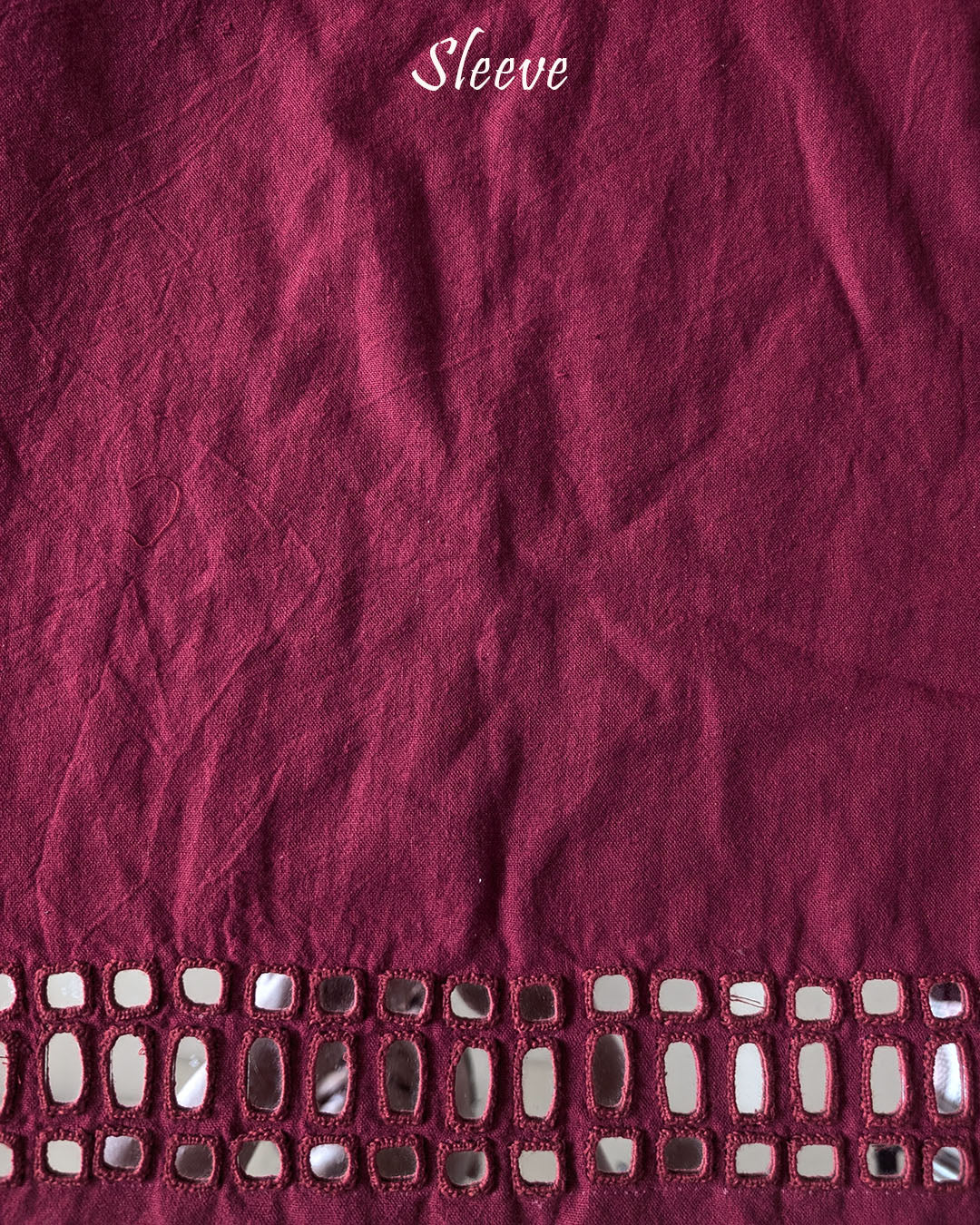 Sleeve detail of the Deep Red Kala Cotton Kutch Mirror Handwork blouse piece, highlighting the real mirror embellishments, detailed threadwork and rich deep red cotton fabric.