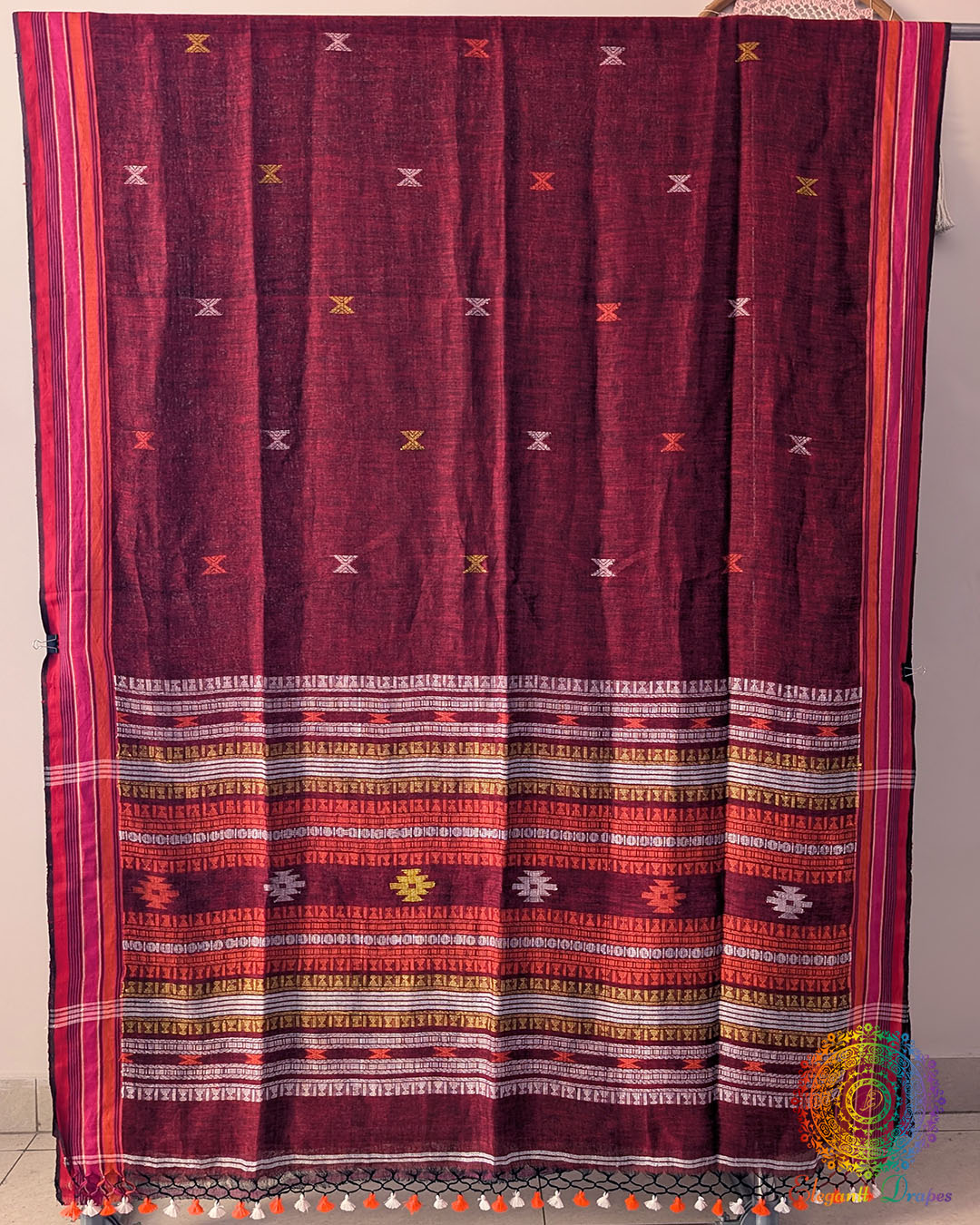 Full red linen saree laid open showing Bhujodi weave pattern and layout