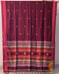 Full red linen saree laid open showing Bhujodi weave pattern and layout