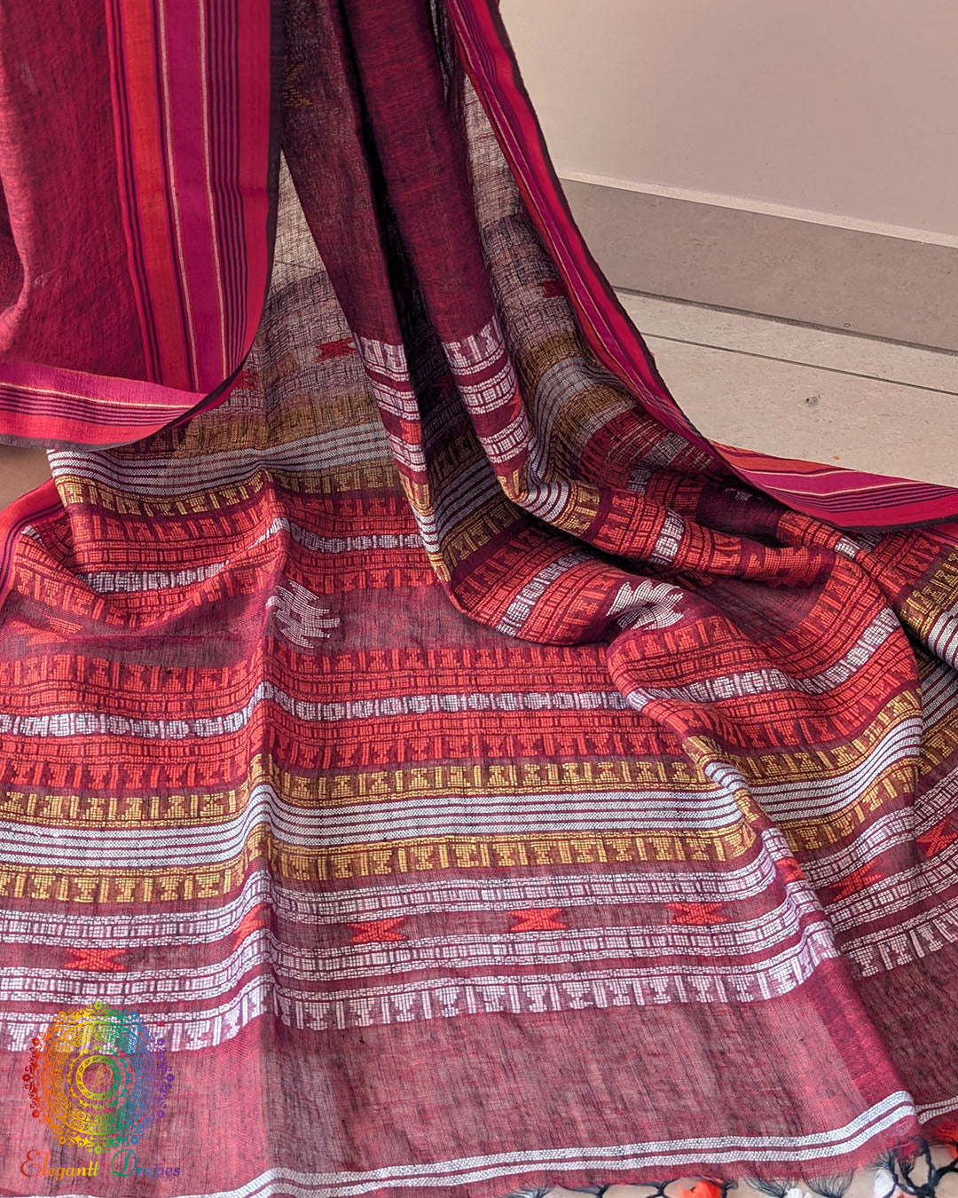 Palla close up on red linen saree highlighting Bhujodi weave detail