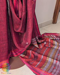 Pleats detail of red linen saree showing texture and structured drape