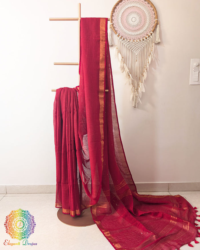 Red linen saree with sequins on mannequin showing complete drape