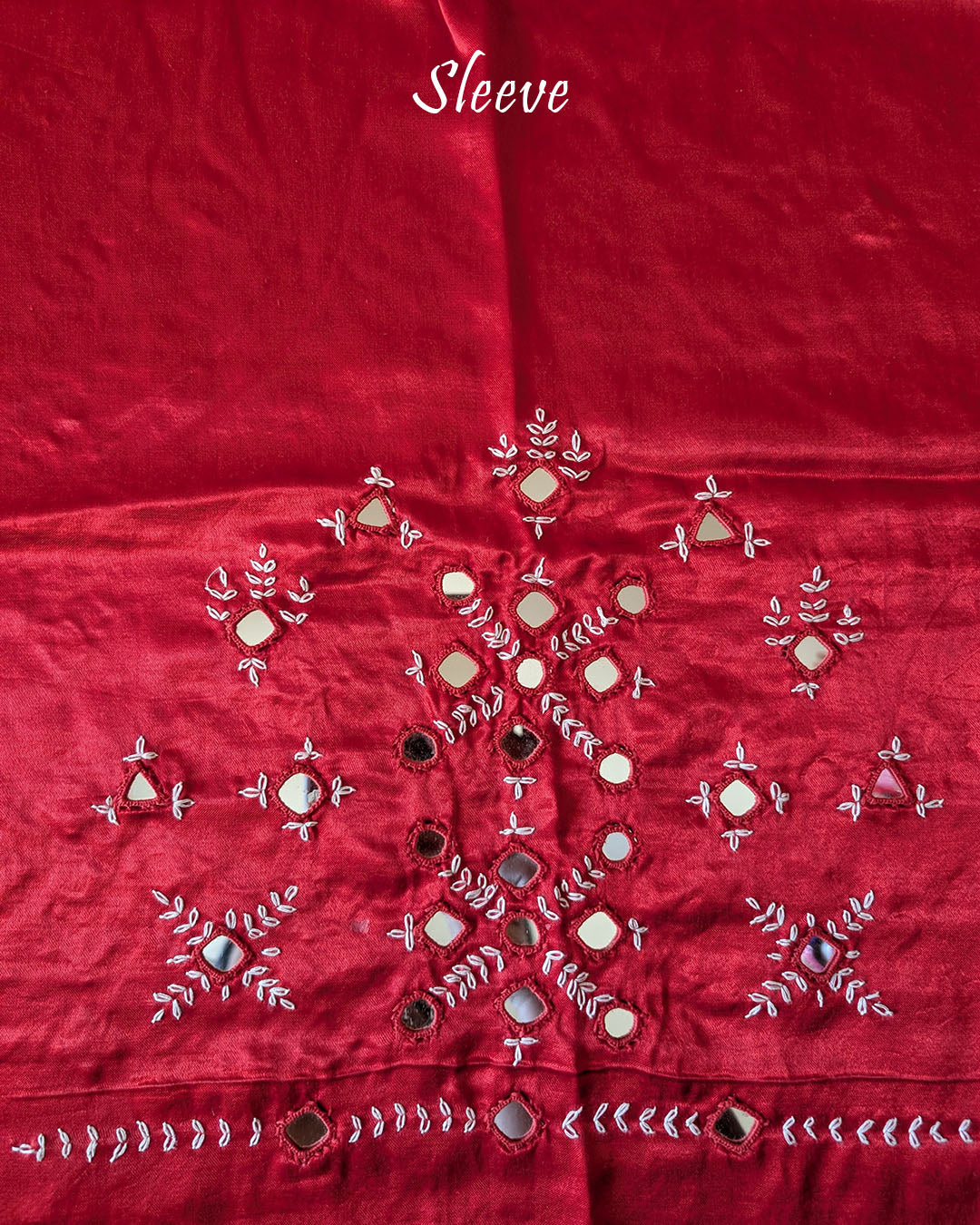 Close-up of Kutch mirror embroidery on sleeve of Red Mashru Silk Blouse Piece