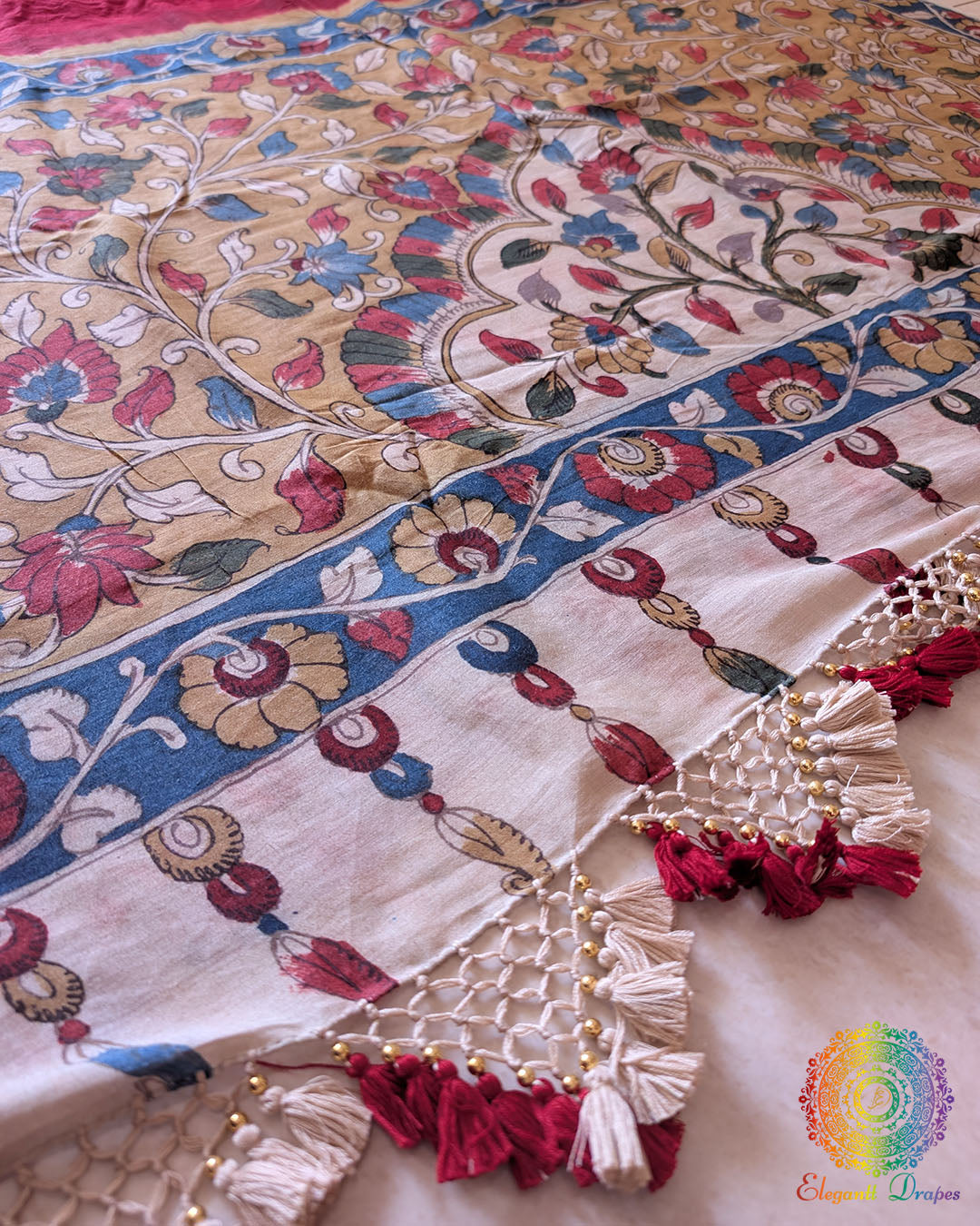 Close-up of the handcrafted heavy tassels adorning the pallu of the Red Bandhani Kalamkari Muga Silk Saree