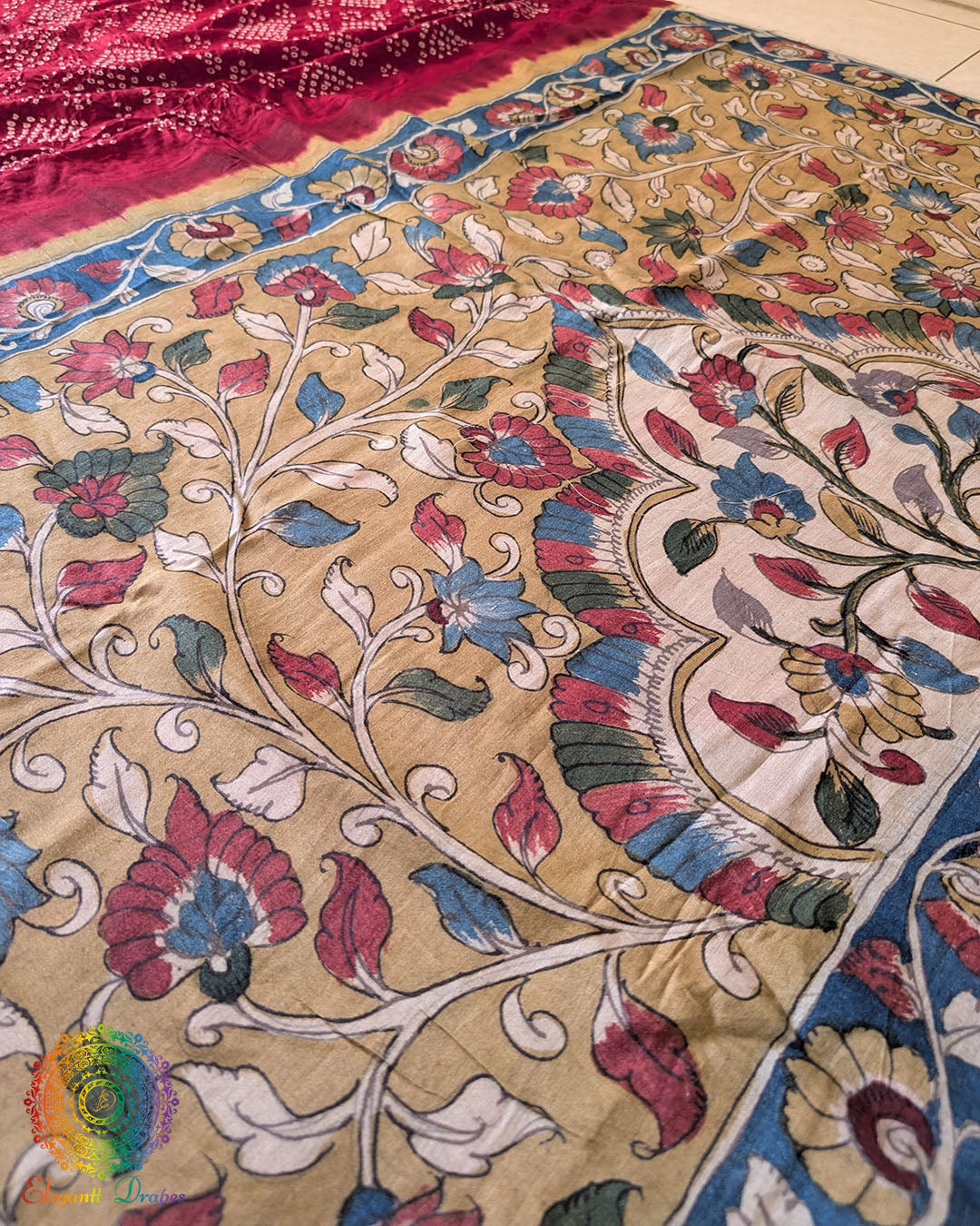 Full flat lay of the Red Bandhani Kalamkari Muga Silk Saree showcasing the complete Bandhani body and Kalamkari pallu