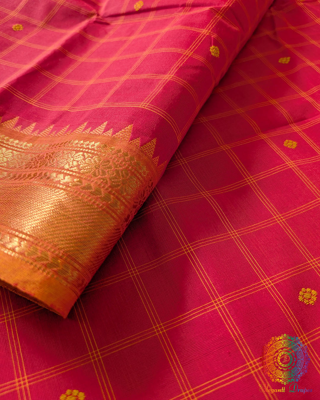 Red Kanchi cotton checkered saree close up highlighting orange border, checks pattern, and fabric texture