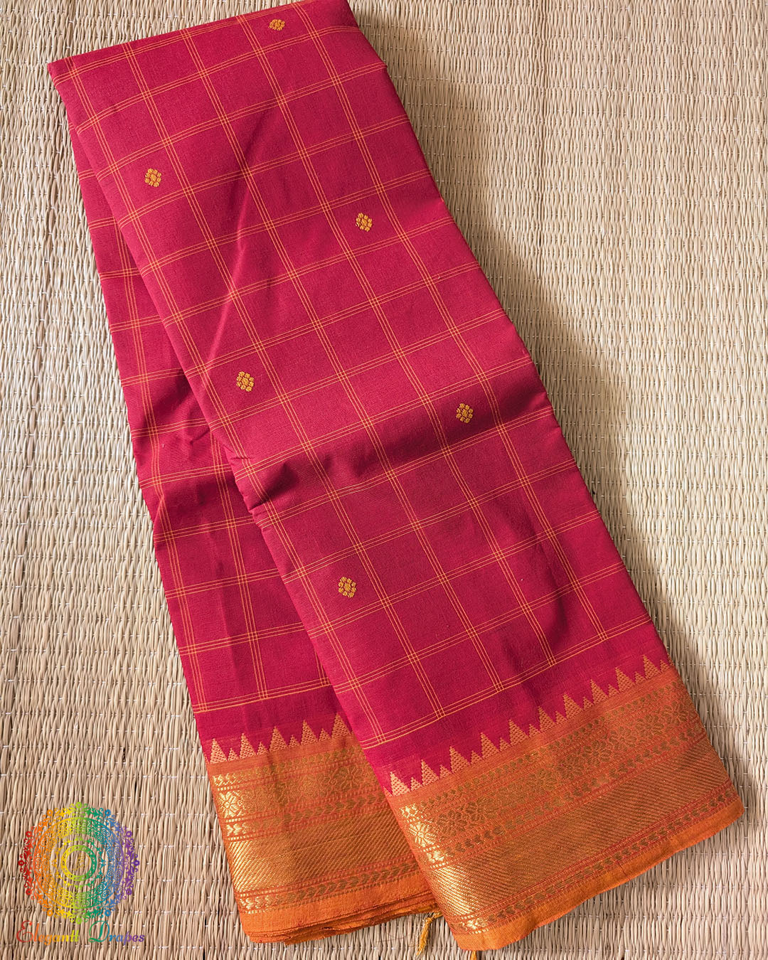 Folded red pure Kanchi cotton checkered saree showing orange border detail