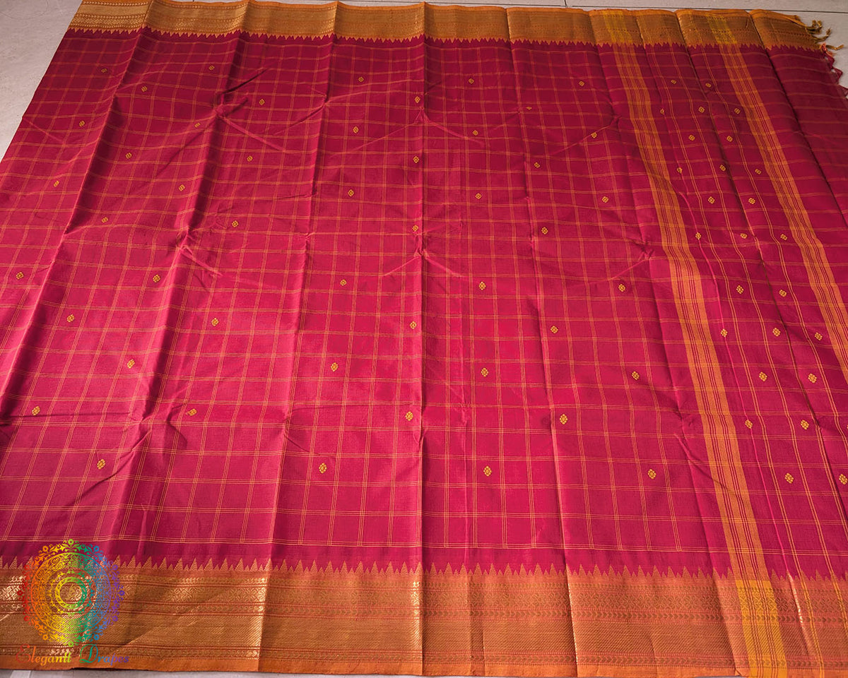 Full red Kanchi cotton checkered saree laid open showcasing orange border and overall design