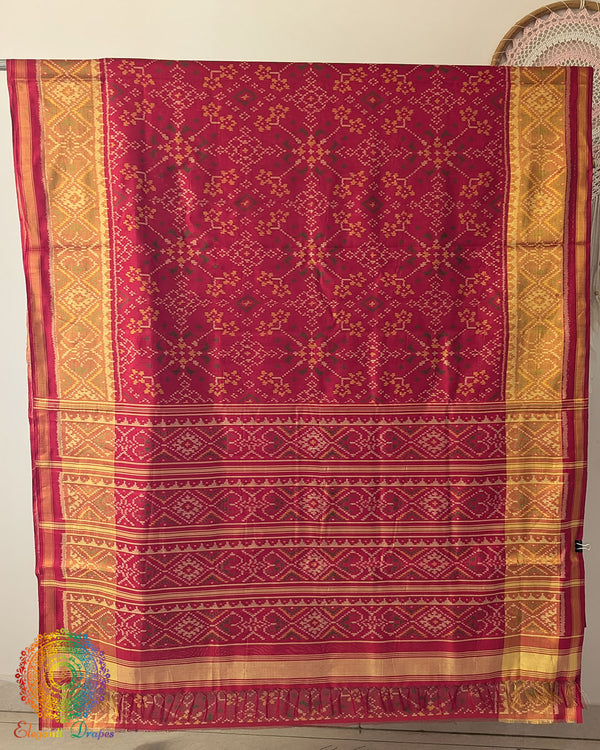 Open palla view of red Rajkot Patola pure mulberry silk saree displaying traditional design