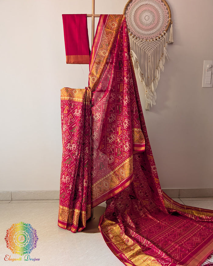 Festive red handwoven mulberry silk Rajkot Patola saree on mannequin showing full drape
