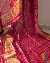 Festive red Rajkot Patola saree palla close up highlighting intricate woven motifs