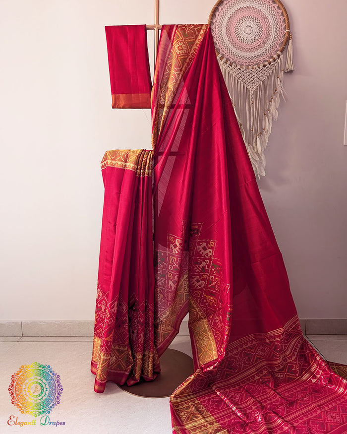 Red mulberry silk Patola saree on mannequin showcasing woven motifs