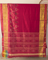 Red handwoven mulberry silk Rajkot Patola saree on mannequin showing full drape