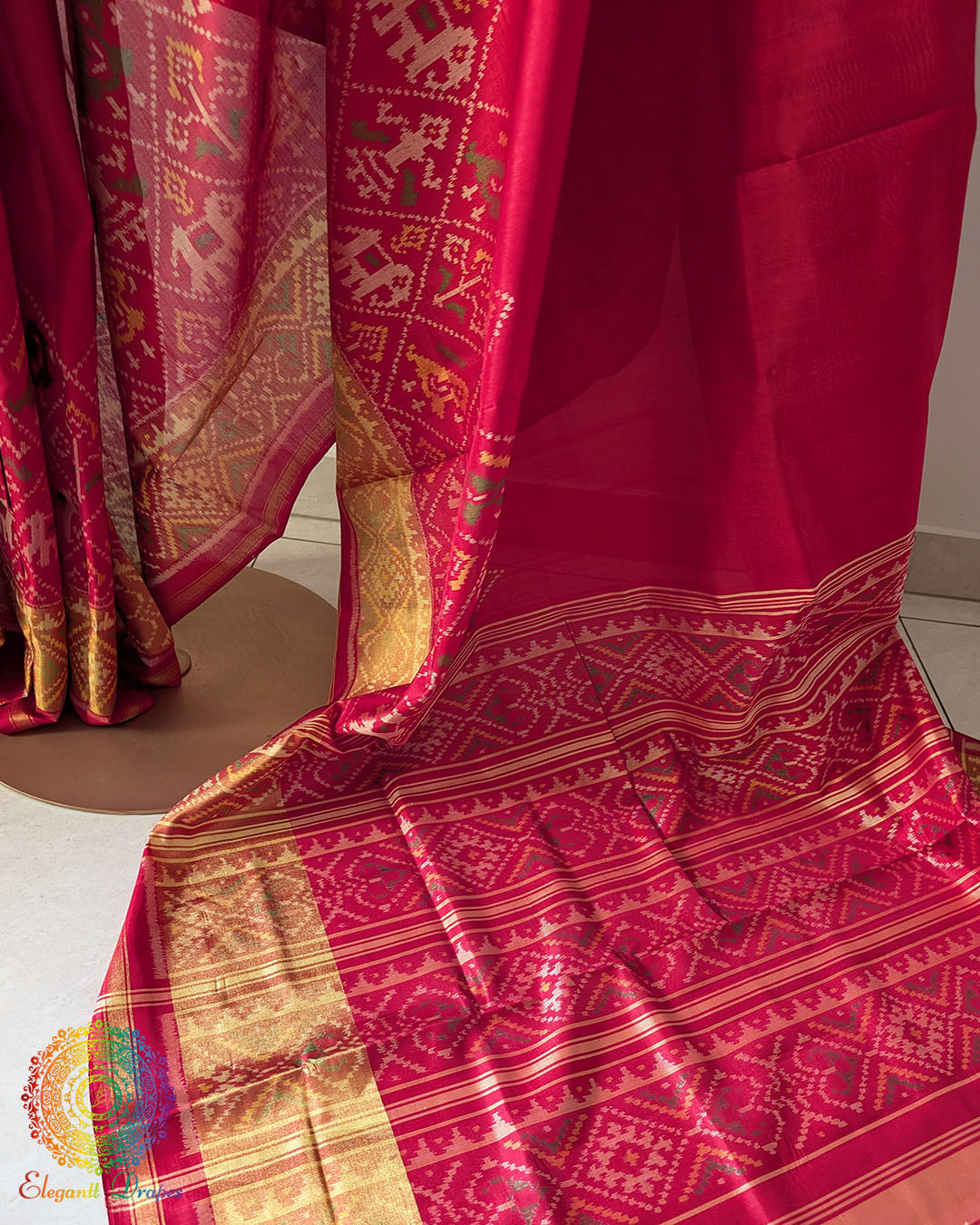 Palla close up on red handwoven Rajkot Patola saree highlighting intricate weaving