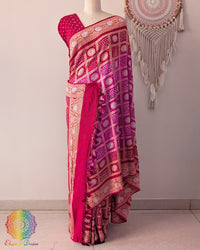 Red pink georgette saree on mannequin showcasing Gharchola pattern and zari weave