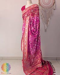 Side angle view of red pink bandhej saree highlighting graceful palla fall