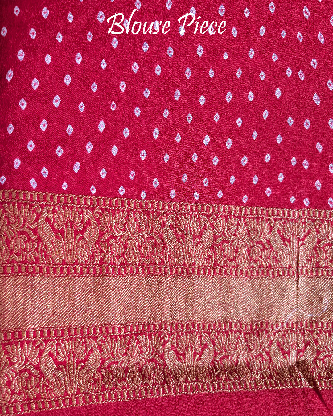 Matching blouse piece in red Banarasi khaddi georgette fabric showing weave detail