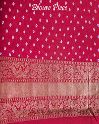 Matching blouse piece in red Banarasi khaddi georgette fabric showing weave detail
