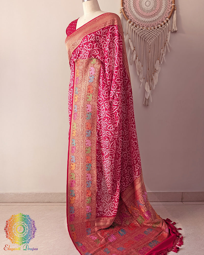 Side angle view of red meenakari bandhani saree highlighting graceful palla fall
