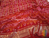 Red Gharchola Bandhani saree drape showing silk texture