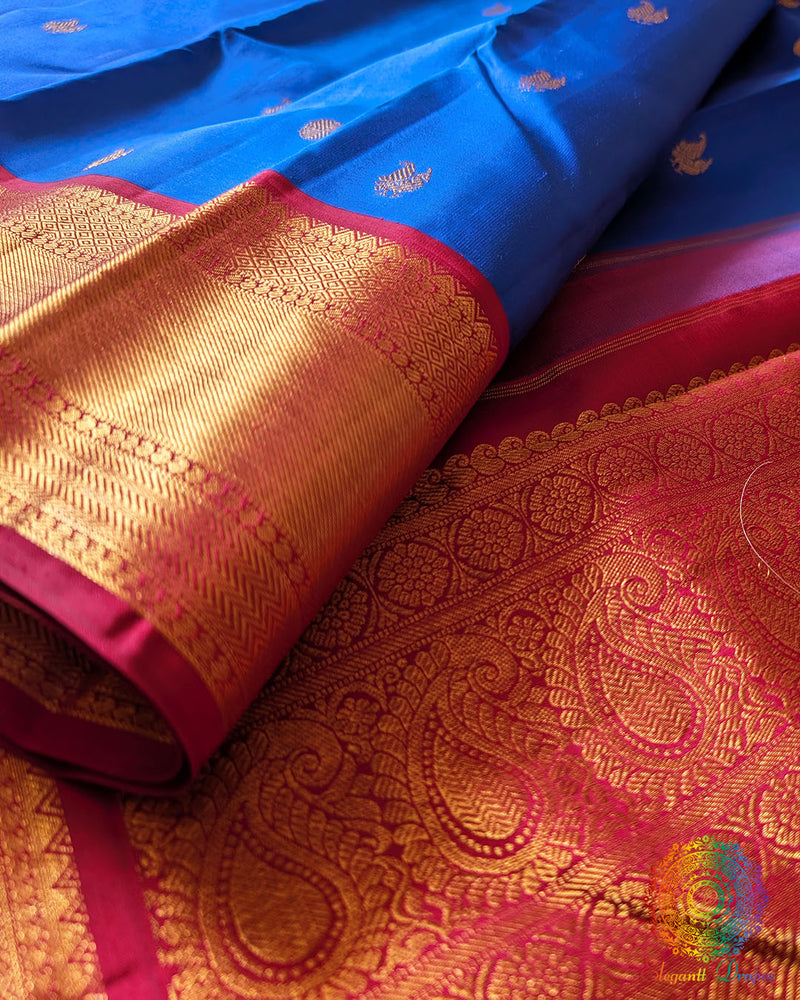 Red border close up on royal blue Kanjivaram silk saree highlighting zari weaving