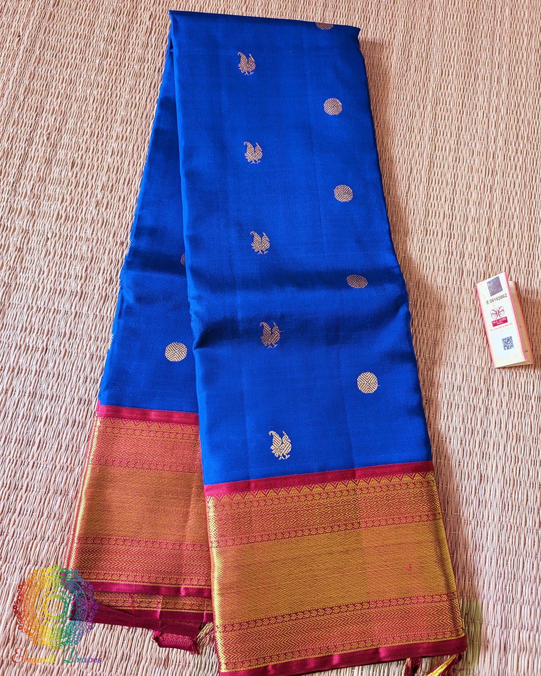 Folded royal blue Kanjivaram silk saree showing red border and 2 gram zari weaving