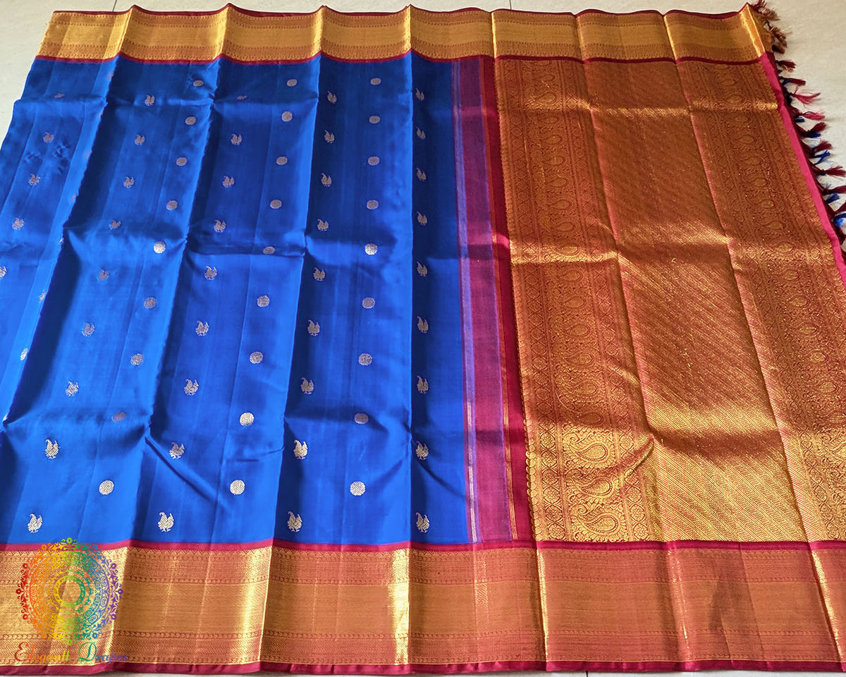 Full royal blue Kanjivaram silk saree laid open showing red palla and woven design