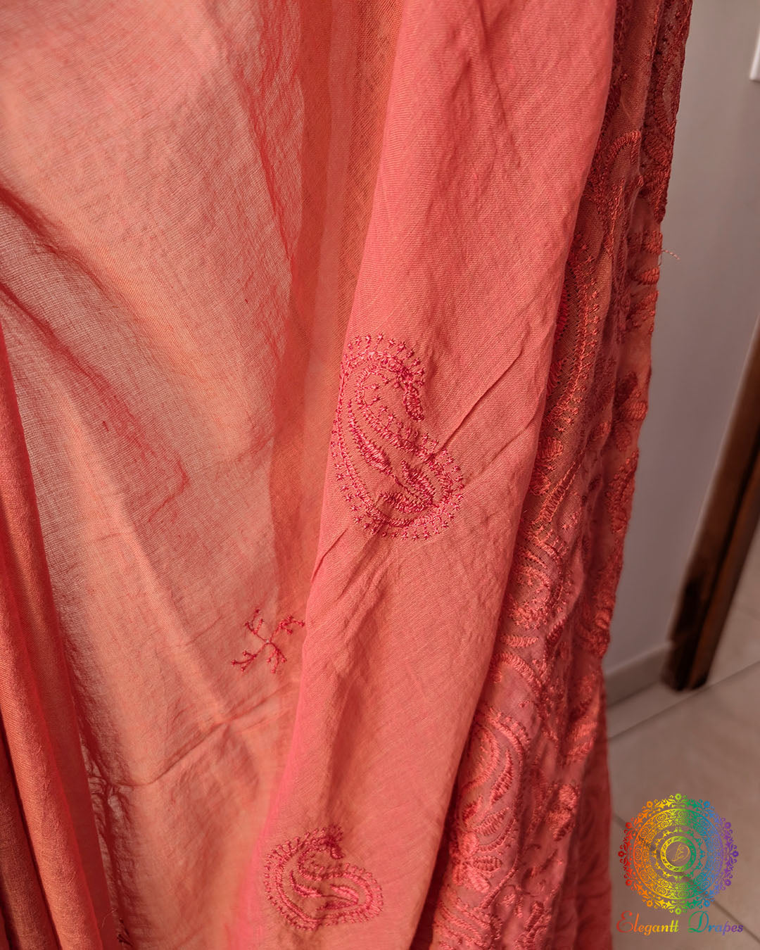 Close up of Chikankari-inspired paisley embroidery on rust brown Bengal cotton saree