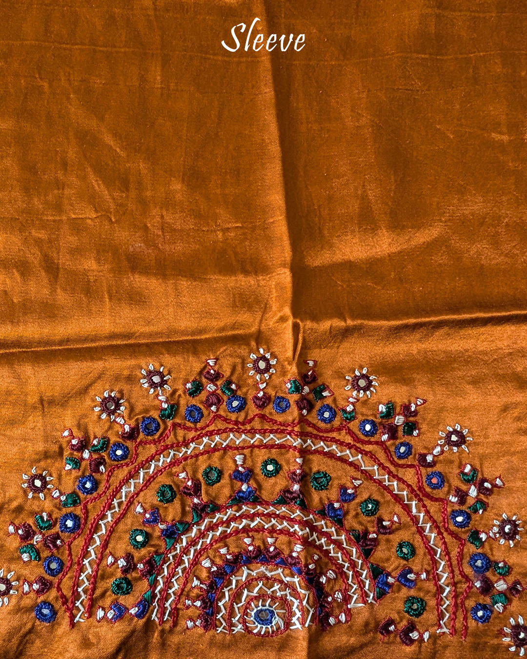 Close-up of semi-circular Bavadiya handwork on Rust Orange Mashru Silk Blouse Piece sleeve