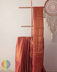 Close up of rust orange Bengal mul tissue saree with sequins work