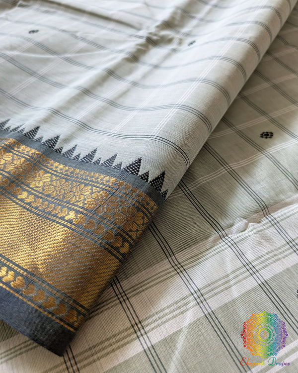 Sage green Kanchi cotton saree close up highlighting all-over checks pattern and fabric texture