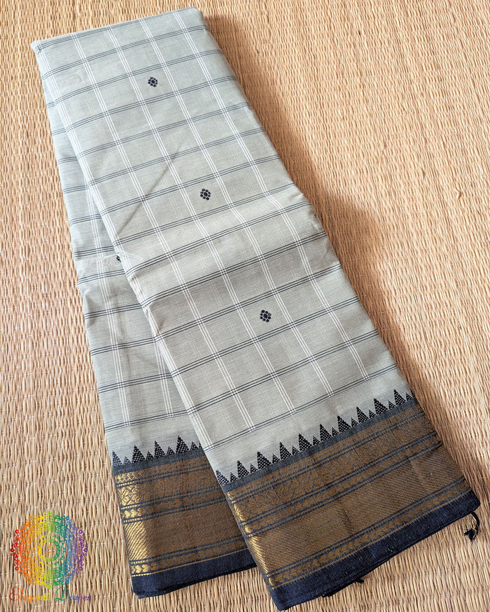 Folded sage green pure Kanchi cotton saree showing all-over checks pattern