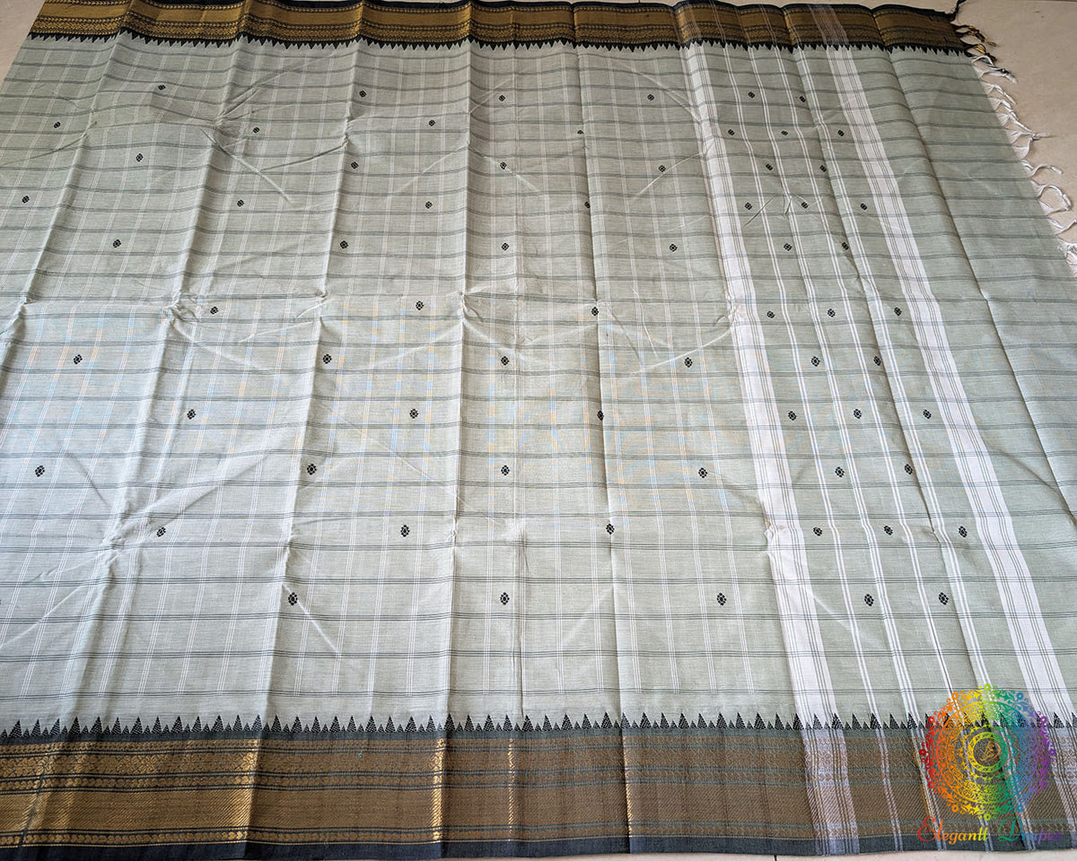 Full sage green Kanchi cotton saree laid open showcasing all-over checks design