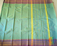 Full sea green Kanchi cotton saree laid flat showing complete design and drape