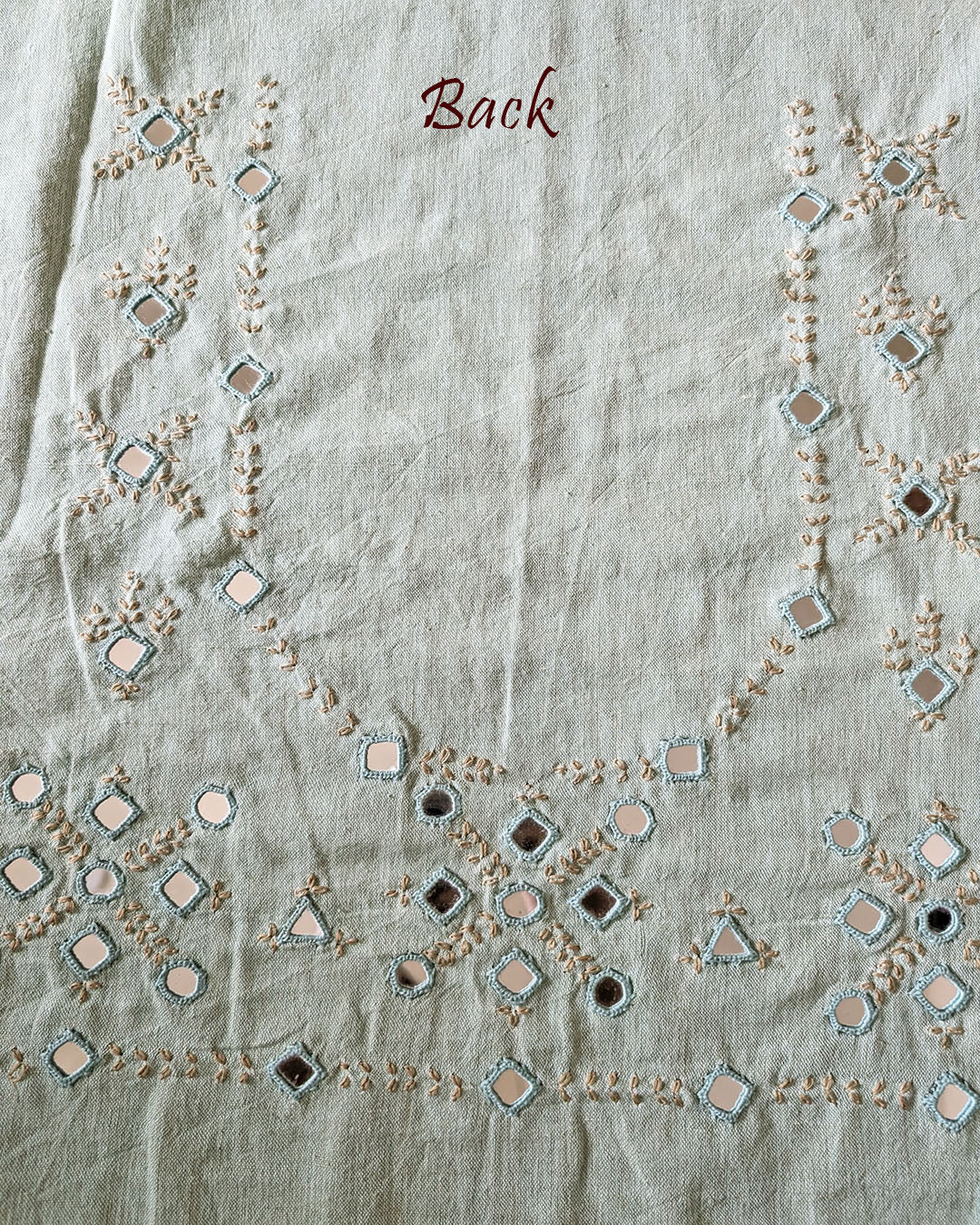 Back view of the Sea Green Kala Cotton Kutch Mirror Handwork blouse piece, showcasing intricate Kutch embroidery and real mirrors arranged in a decorative handcrafted design.