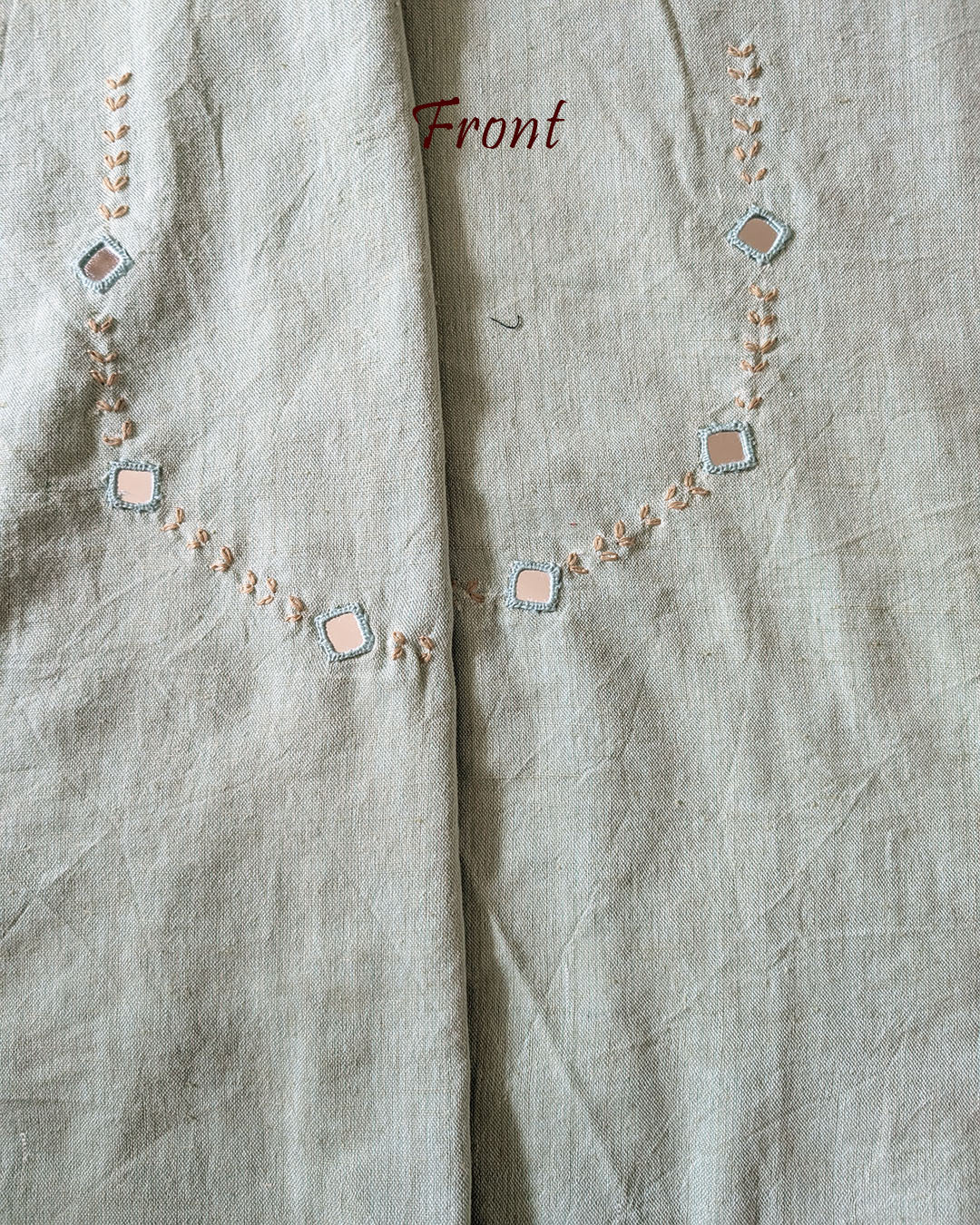 Front neck of the Sea Green Kala Cotton Kutch Mirror Handwork blouse piece, showcasing intricate Kutch embroidery and real mirrors arranged in a decorative handcrafted design.