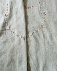 Front neck of the Sea Green Kala Cotton Kutch Mirror Handwork blouse piece, showcasing intricate Kutch embroidery and real mirrors arranged in a decorative handcrafted design.