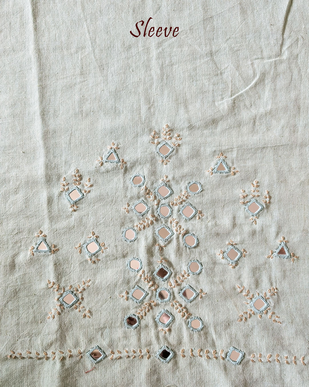 Sleeve detail of the Sea Green Kala Cotton Kutch Mirror Handwork blouse piece, highlighting the real mirror embellishments, detailed threadwork and refreshing sea green cotton fabric.