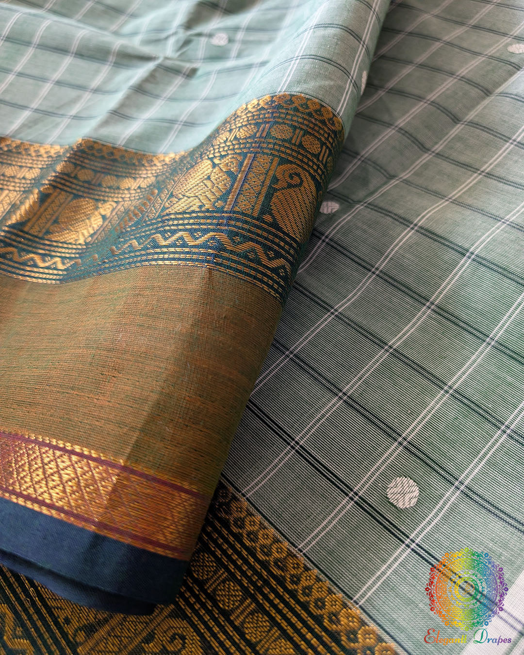 Sea green Kanchi cotton saree close up highlighting checkered pattern and fabric texture