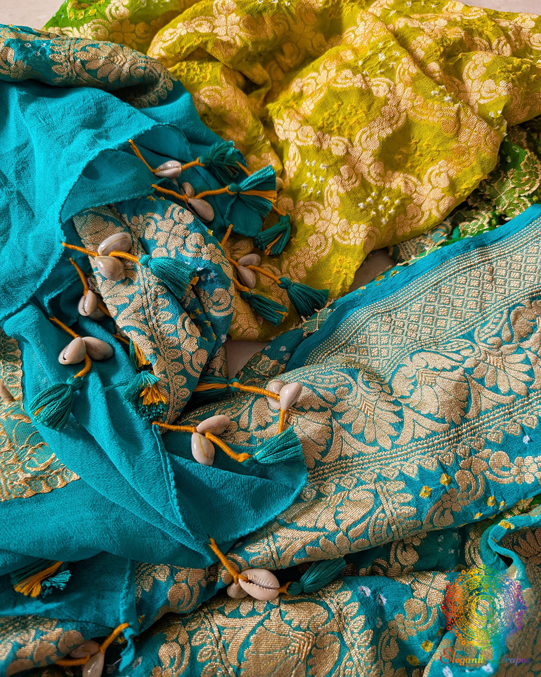 Close-up of traditional kodi tassels, zari border, Gharchola checks, and Bandhani motifs on sea green and yellow shaded Banarasi georgette dupatta