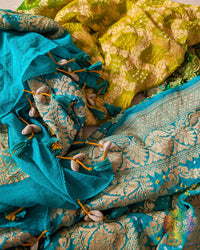Close-up of traditional kodi tassels, zari border, Gharchola checks, and Bandhani motifs on sea green and yellow shaded Banarasi georgette dupatta