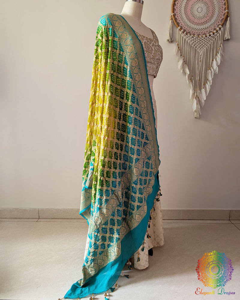 Side view of sea green and yellow shaded Banarasi georgette Gharchola Bandhani dupatta showcasing elegant ombré effect, Gharchola checks, and Bandhani motifs