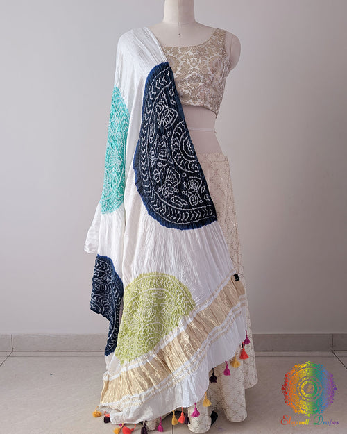 White Gajji Silk Multicolour Bandhani Dupatta in a full draped view, showcasing the white base decorated with navy blue, sea green, mauve, pink and green Bandhani motifs.